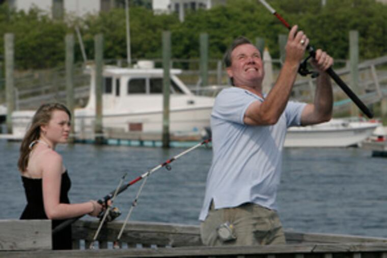 David Byrne, a regular customer of the Hodge Podge bait and tackle shop in Avalon, fishing from his home's dock with his daughter Meg Byrne. He's been coming to Avalon since he was a boy, he said.