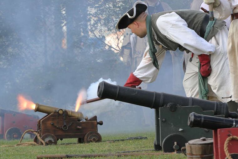Nick Holicky of Baltimore fires off a replica cannon with others, signaling the start of the Marcus Hook Pirate Festival. MICHAEL BRYANT / Staff Photographer