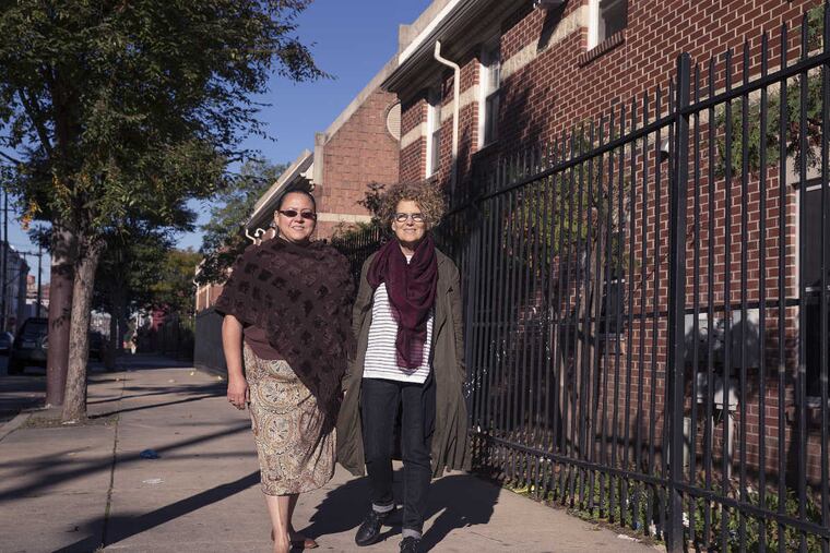 Norma Santiago (left), a board member at Women's Community Revitalization Project who is also a tenant at the first development the project built, and project CEO Nora Lichtash.