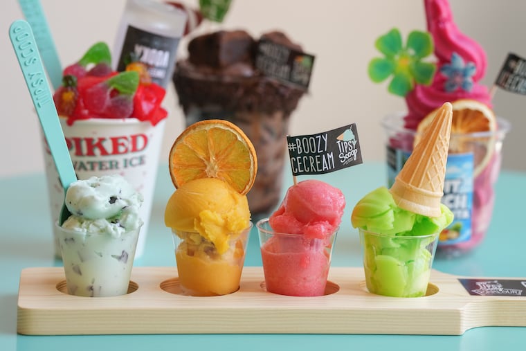 A flight of four boozy ice cream with sundaes in the background at Tipsy Scoop, 119 S. 18th St. The NYC-based chain is opening its first Philly location on May 9, 2026.