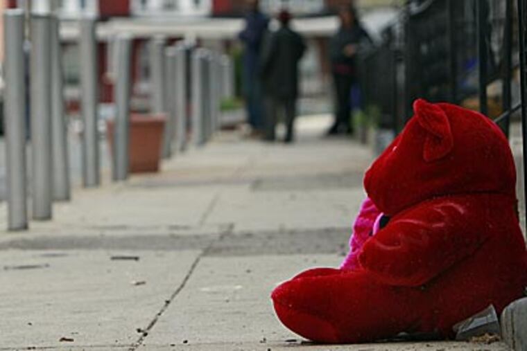 The scene where Halim Lindsey was gunned down in West Philadelphia. Lindsey was shot 12 times on Redfield Street. A memorial rests where Lindsey was
killed. (David Maialetti / Staff Photographer)