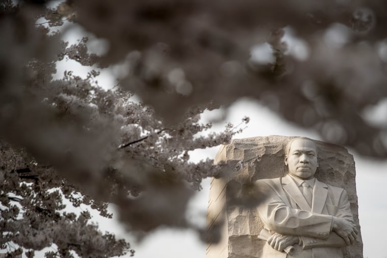 The Martin Luther King, Jr. Memorial is visible through cherry blossom trees along the Tidal Basin, Saturday, March 30, 2019, in Washington.