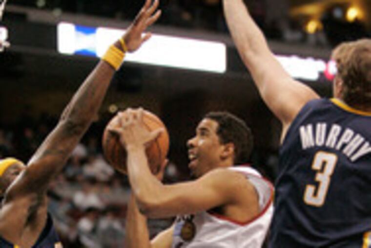The Sixers' Andre Miller drives to the basket between Indiana defenders (from left) Jermaine O'Neal, Keith McLeod and Troy Murphy at the Wachovia Center. E3.