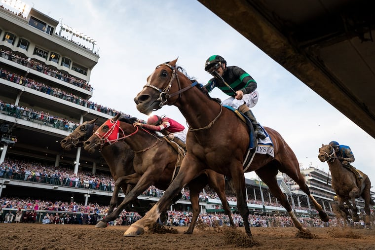 Mystik Dan crosses the finish line to win last year's Kentucky Derby. The 151st Run for the Roses is Saturday at Churchill Downs in Louisville, Ky.