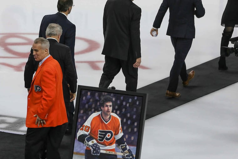 Wearing his orange blazer, former Philadelphia defenseman Jim Watson leaves following his Flyers Hall of Fame induction ceremony Monday, February 29, 2016. STEVEN M. FALK / Staff Photographer
