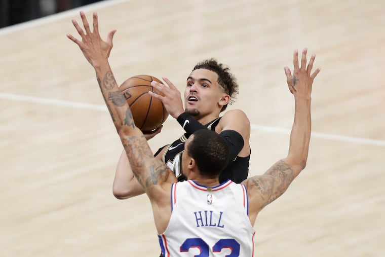 Atlanta Hawks guard Trae Young shoots over the Sixers' George Hill in Game 6 of the NBA Eastern Conference semifinals on Friday, June 18, 2021 in Atlanta.