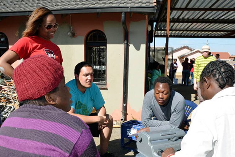 Temple University students Taylor Lumpkin, Ezra Lewis with blind young adult residents of the Emathonsini Home, Annah Letlape and Mlungisi Shabalal and Paul Hlongwane. (Linn WashingtonPhoto)