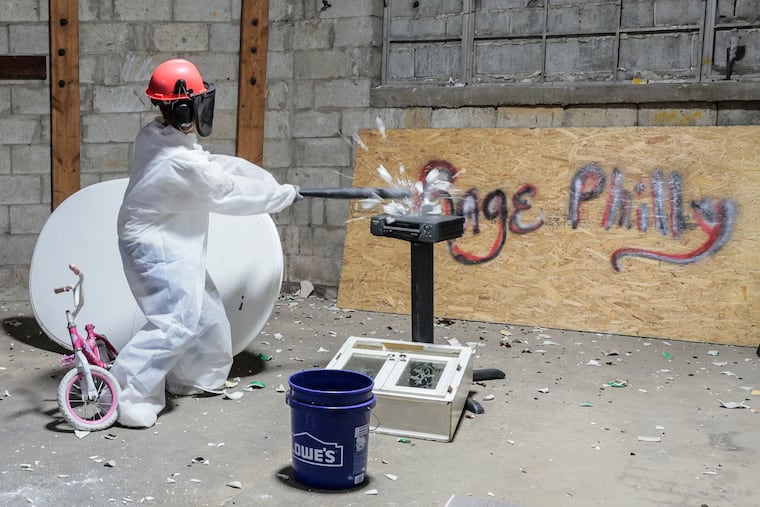 Reagen Price takes out a mug at Rage Room Philadelphia. Rage rooms are all the rage across the U.S. as the trend to go to a warehouse and break household items became popular in recent years. Friday August 4, 2023.