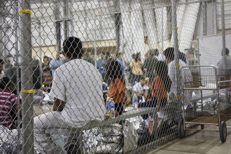 In this photo provided by U.S. Customs and Border Protection, people who've been taken into custody related to cases of illegal entry into the United States, sit in one of the cages at a facility in McAllen, Texas, Sunday, June 17, 2018.