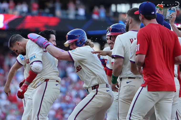Philadelphia Phillies outfielder Harrison Bader (center) celebrates with Philadelphia Phillies outfielder Nick Castellanos (left) after he scored on Castellanos’ sacrifice fly to win the game at Citizens Bank Park in Philadelphia on Sunday, Sept. 28, 2025. Phillies win in ten innings.