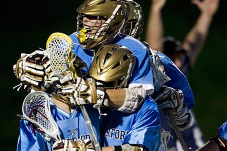 Haverford School teammates mob Carl Walrath (left) after he tied the game with 36 seconds remaining. (Ed Hille/Staff Photographer)
