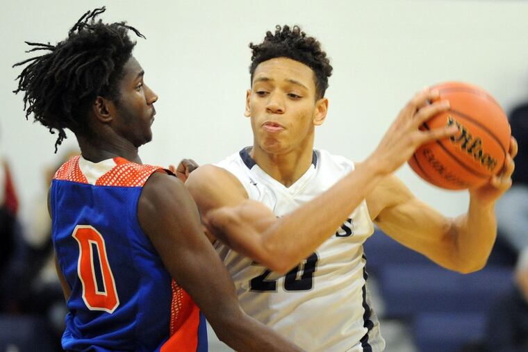 Millville’s Rynell Lawrence (left), pictured defending against St. Augustine’s Marlon Hargis in a game back on Dec. 18, scored 21 points in Monday's 54-49 win over St. Joseph.