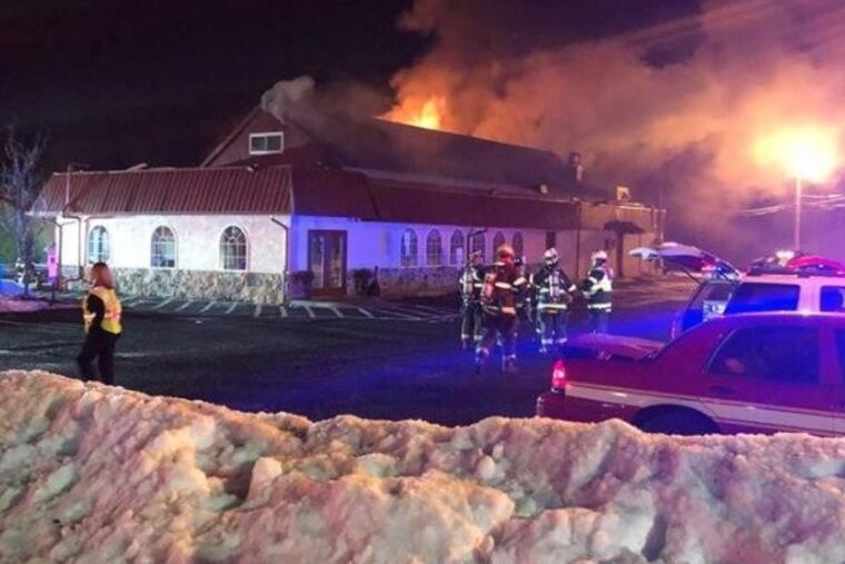 Fire burns through the roof of the the Country Town Diner.