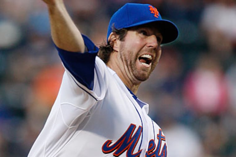 R.A. Dickey threw six shutout innings in the Mets' win over the Phillies. (Kathy Willens/AP)