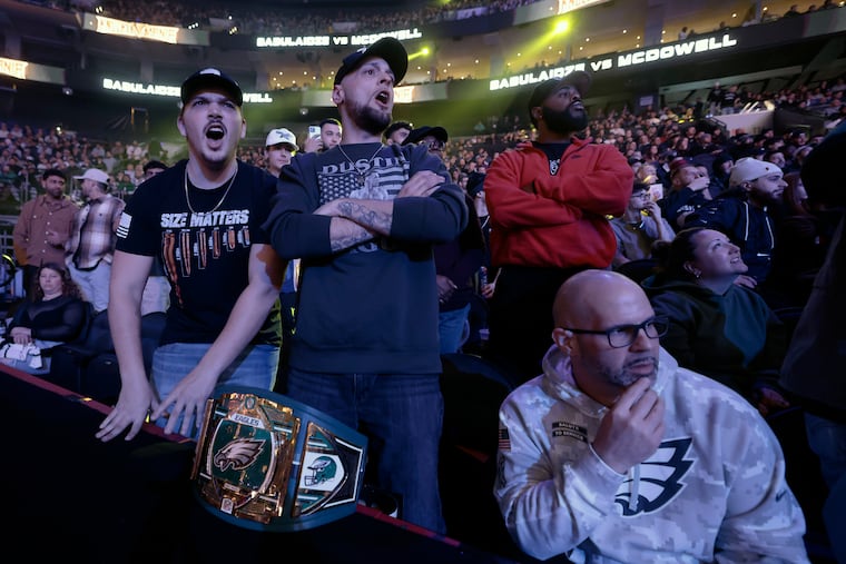 (Front row left-right) Logan Gipe, Steve Harper, and Jim Gottshall of Carlisle, Pa. brought an Eagles championship belt to BKFC's KnuckleMania V at the Wells Fargo Center on January 25, 2025.