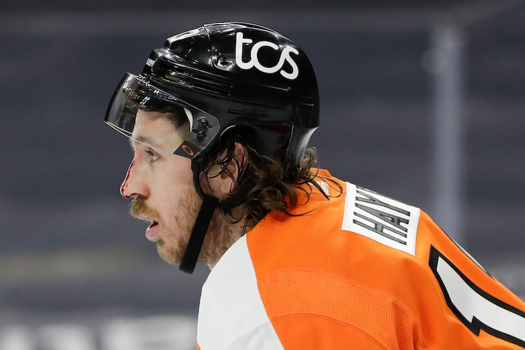 Kevin Hayes skates off the ice as blood runs down his nose during the second period in Monday's overtime loss to the Islanders.
