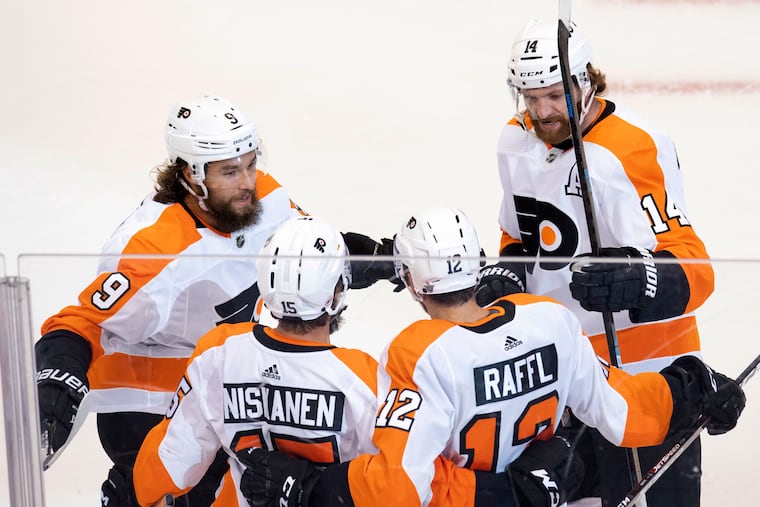 Philadelphia Flyers left wing Michael Raffl (12) is congratulated by teammates defenceman Ivan Provorov (9), defenceman Matt Niskanen (15) and centre Sean Couturier (14) after scoring on the Montreal Canadiens.