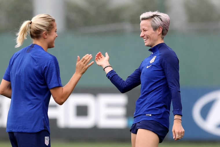 U.S. women's soccer team players Abby Dahlkemper (left) and Megan Rapinoe share a laugh during a training session on Monday.