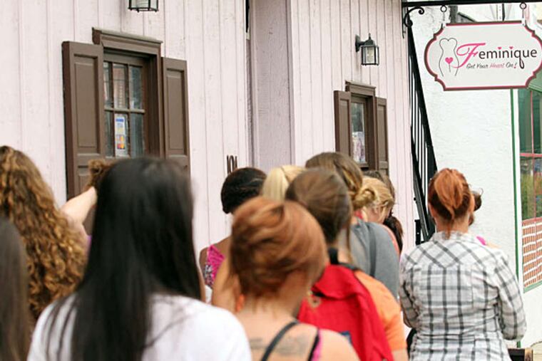 Hundreds of curious customers lined up at the Feminique boutique Sunday to get a free vibrator.