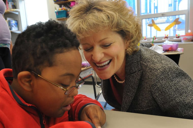 Bancroft CEO Toni Pergolin with Makhi Terrell, 7, at the Bancroft School in Cherry Hill. The nonprofit was in tough financial shape when she arrived there as chief finance officer in 2004.
