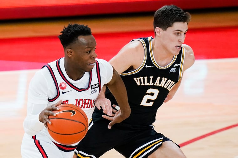 St. John's Rasheem Dunn drives past Villanova's Collin Gillespie during the first half.