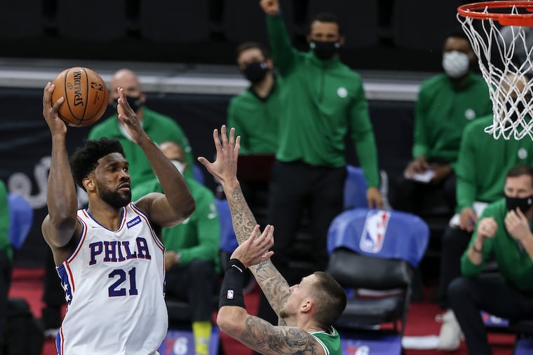 Sixers' Joel Embiid looks to shoot over Celtics' Daniel Theis during the second quarter at the Wells Fargo Center.