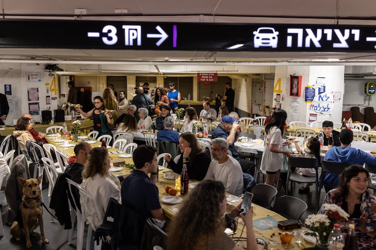 People gather for a communal Passover seder in an underground parking lot that serves as a bomb shelter in Tel Aviv on Wednesday.