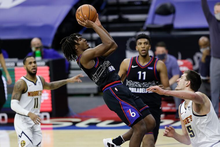 Sixers guard Tyrese Maxey shoots over Denver Nuggets center Nikola Jokic during the third quarter.