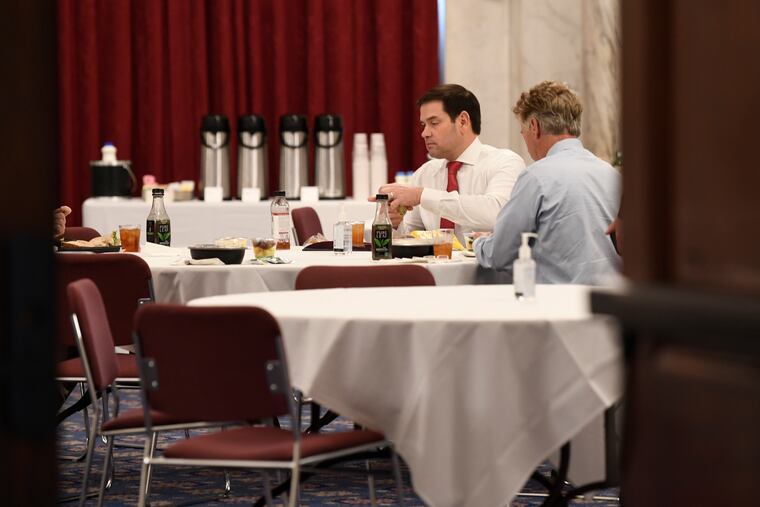 Sen. Rand Paul, R-Ky., right, Sen. Marco Rubio, R-Fla., left, have lunch at a Republican policy lunch on Capitol Hill on Friday.