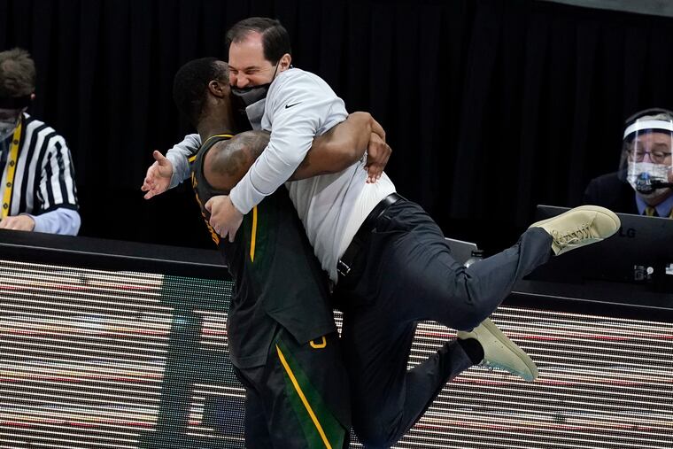 Baylor head coach Scott Drew gets a hug from guard Mark Vital at the end of the championship game against Gonzaga.