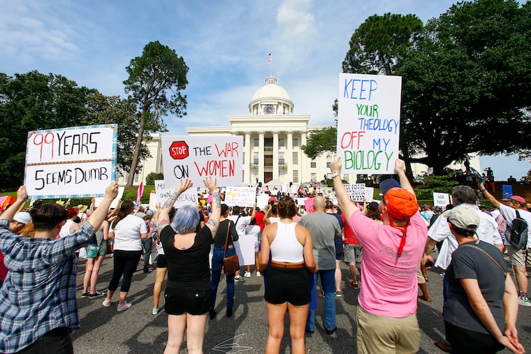 Protesters for women's rights hold a rally on the Alabama Capitol steps to protest a law passed last week making abortion a felony in nearly all cases with no exceptions for cases of rape or incest, Sunday, May 19, 2019, in Montgomery, Ala.