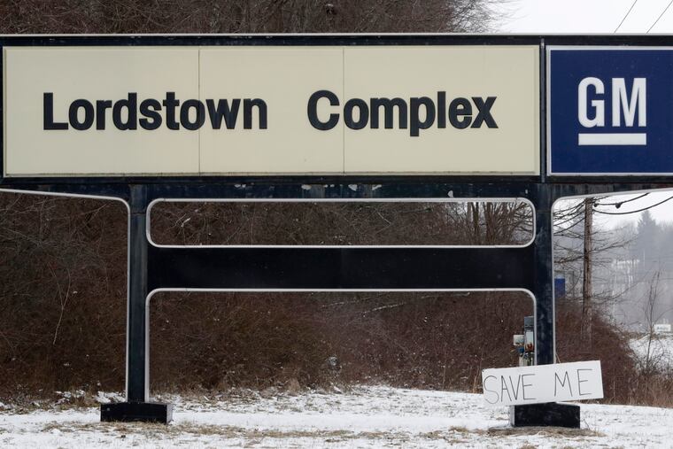 FILE - In this March 6, 2019, file photo, a "Save Me" sign rests against the General Motors Lordstown Complex sign in Lordstown, Ohio. General Motors plans to sell its shuttered factory in Lordstown, to a company that builds electric trucks. President Donald Trump announced the deal Wednesday morning, May 8, 2019, on Twitter. (AP Photo/Tony Dejak, File)