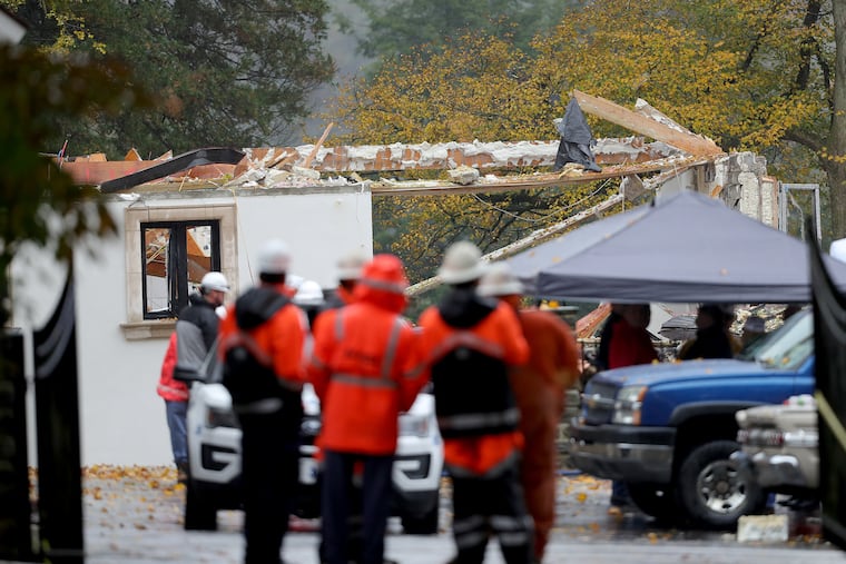 Utility and emergency workers gather at the scene a day after a gas explosion leveled an empty mansion in Gladwyne, PA on November 5, 2018.