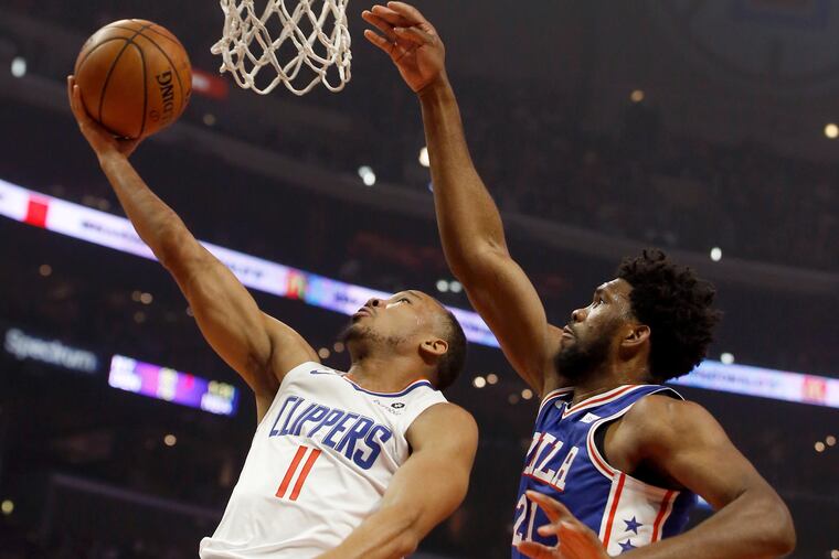 Joel Embiid defends Clippers guard Avery Bradley during the first half.