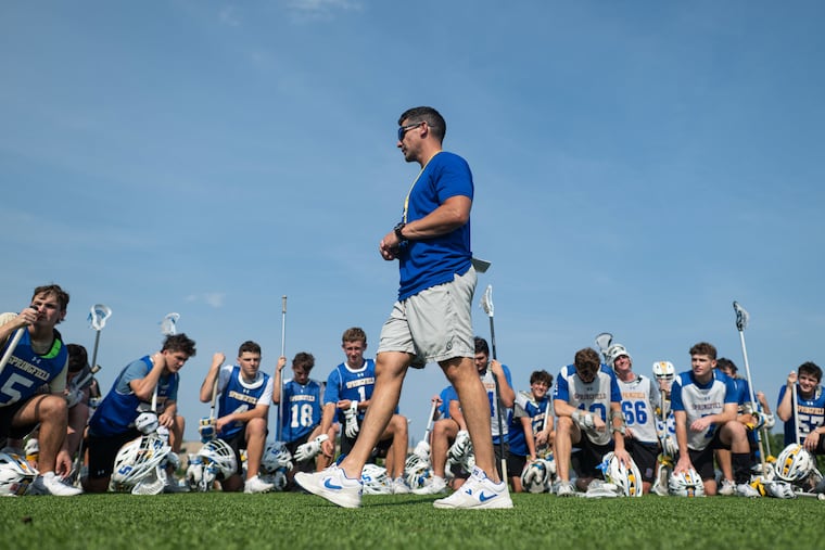 Coach Tom Lemieux delivers a speech at the end of the Springfield boys' lacrosse final practice before the team's championship game.