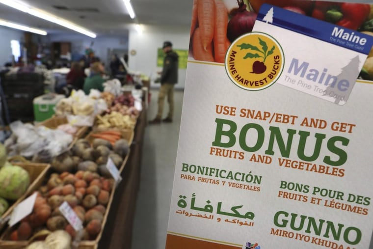 A sign advertises a program that allows food stamp recipients to use their EBT cards to shop.