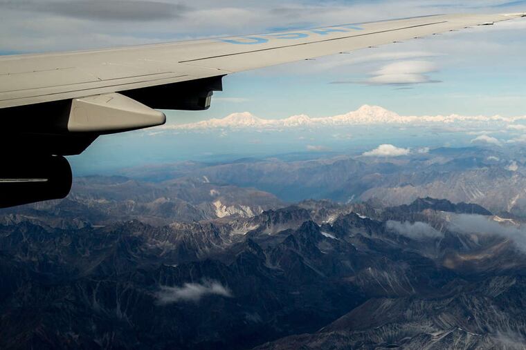 ASSOCIATED PRESS The newly renamed Denali is seen from a window of Air Force One carrying President Obama to Anchorage, Alaska.