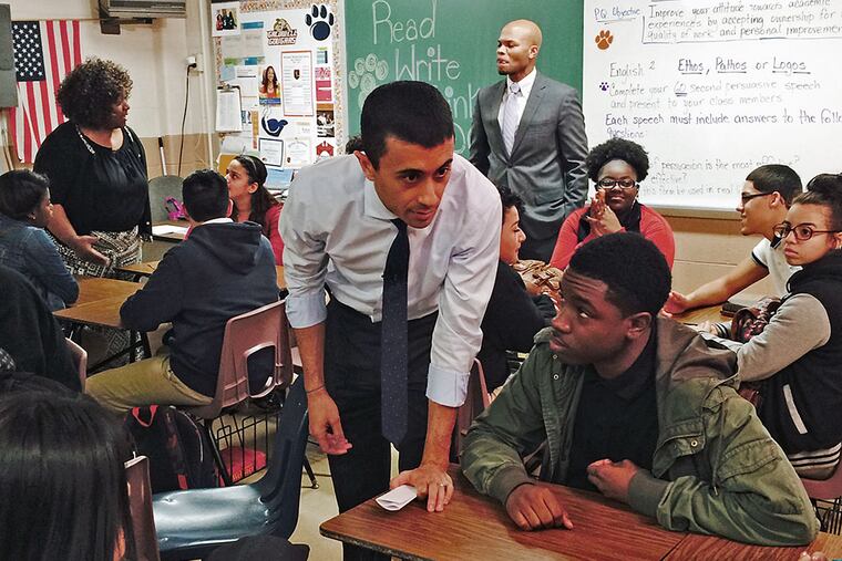Camden School Superintendent Paymon Rouhanifard (center) confers with students at Woodrow Wilson High School. MELANIE BURNEY / Staff
