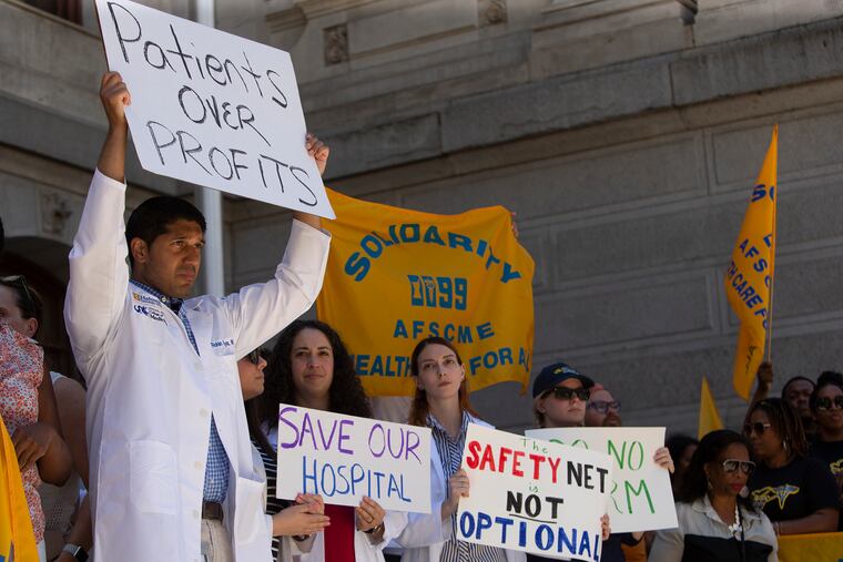 People rally in front of City Hall to save Hahnemann University Hospital from closing.