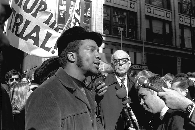 In this Oct. 29, 1969, file photo, Fred Hampton (center), chairman of the Illinois Black Panther Party, speaks at a rally outside the U.S. Courthouse in Chicago while Benjamin Spock (background) listens.