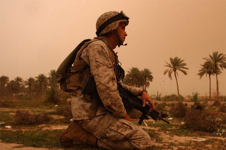 Marine Sgt. Charles Sheldon , Third Squad platoon leader, patrolling near the Euphrates River in Iraq in 2004.