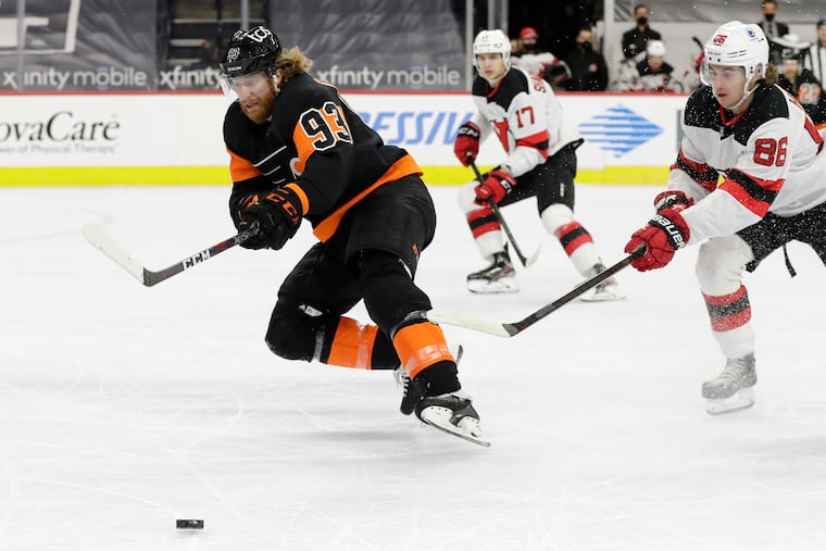 Flyers right winger Jake Voracek (93) skated after the puck against New Jersey Devils center Jack Hughes in a May 1 game at the Wells Fargo Center.