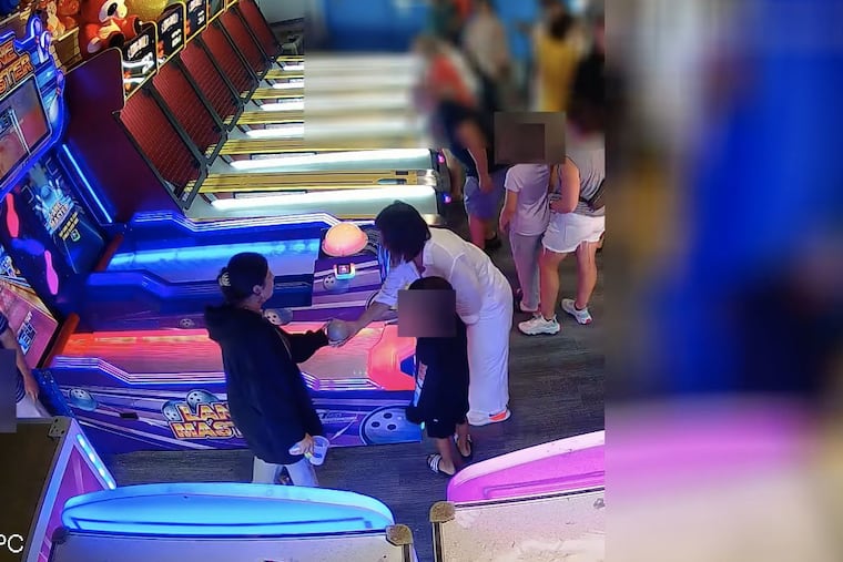 Police in Cape May are seeking to identify the woman in white captured on camera throwing a skee ball that hit the back of a child's head after a dispute with another patron.