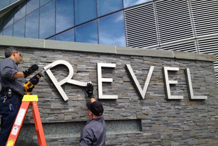 Revel employees Joe Lucchetti, of Turnersville, N.J., left, and Robert Fitting, of Berlin, N.J. remove letters from a sign at Revel hotel-casino, Monday, Sept. 1, 2014, in Atlantic City, N.J. The hotel closed Monday and the casino will close on Tuesday. (AP Photo / The Press of Atlantic City, Michael Ein)