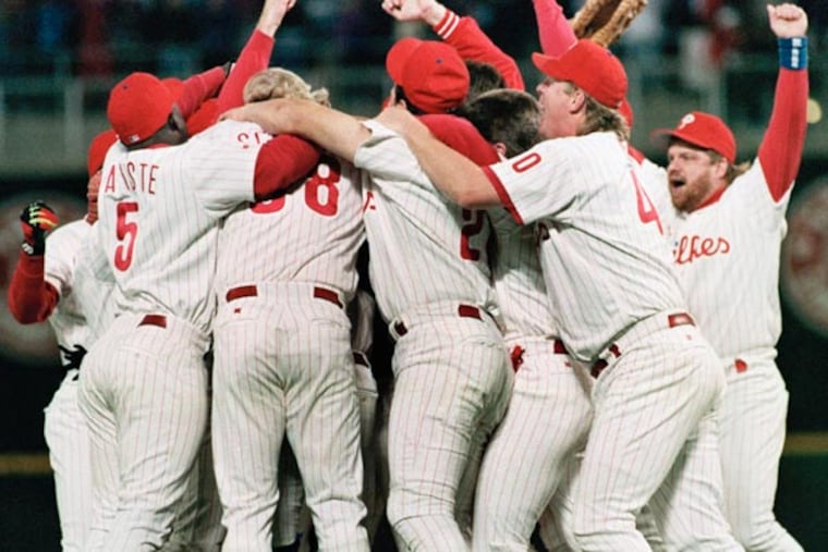 Philadelphia Phillies team members swarm relief pitcher Mitch Williams after the last out in the Phillies 6-3 win over the Atlanta Braves in game 6 of the National League playoff at Veterans Stadium on, Oct. 13, 1993. (Amy Sancetta/AP file)