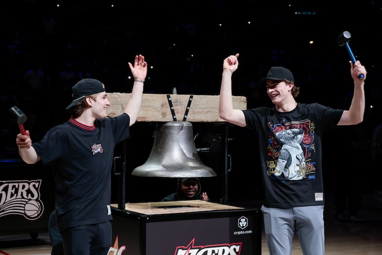 Flyers Denver Barkey, (left) and Porter Martone ring the bell at the start of the Sixers' play-in game on Wednesday.