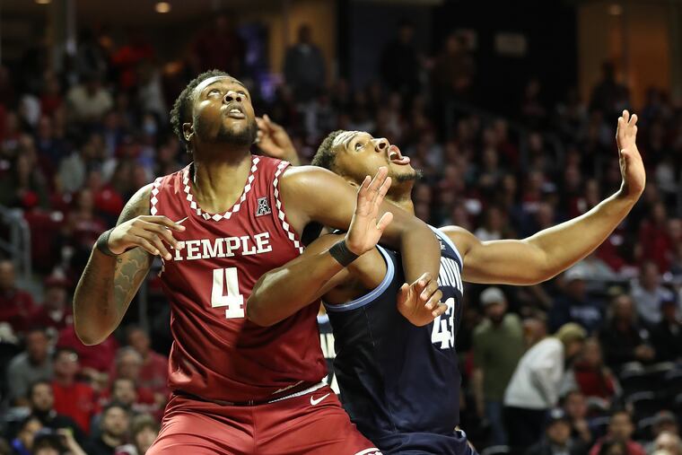 Jamille Reynolds (left) of Temple and Eric Dixon of Villanova battling for rebounding position at the Liacouras Center on Nov. 11.