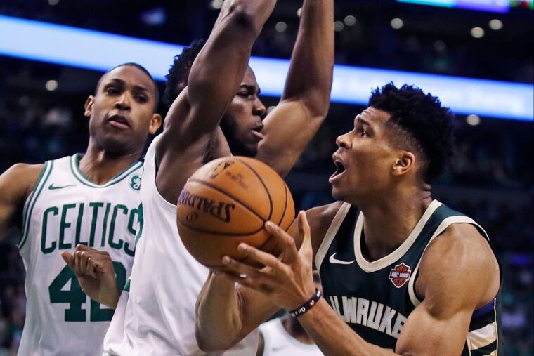 Bucks forward Giannis Antetokounmpo, right, saw a lot of Boston’s Semi Ojeleye during the first-round series.