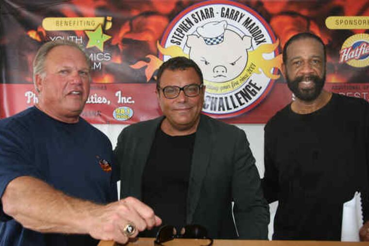 Ex-Phillie Garry Maddox (right) yields center to restaurateur Stephen Starr as they promote their annual barbecue challenge. Joining them Friday at Citizens Bank Park was another Phillies great, Greg Luzinski, who oversees Bull's BBQ there. The challenge, which raised $67,000 for Maddox's Youth Golf and Academics Program last year, is set for Aug. 7 at the stadium.