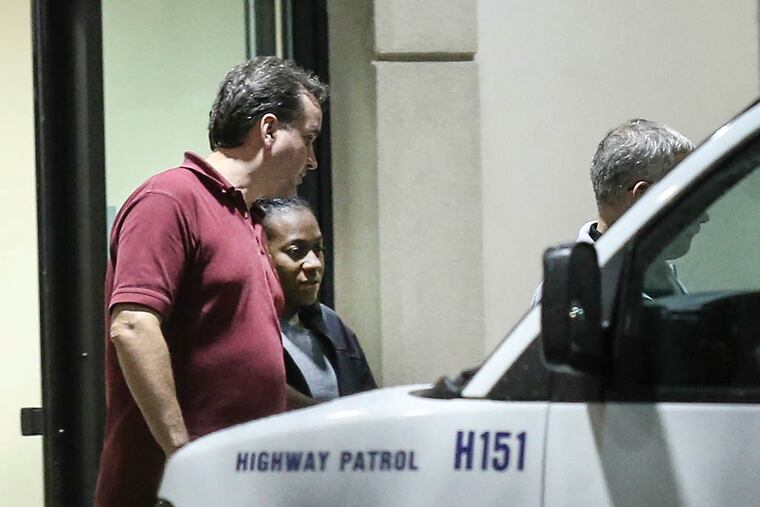Carlesha Freeland-Gaither is escorted from Howard County General Hospital in Columbia, Md., by Philadelphia Detectives James Sloan (left) and John Geliebter early Thursday, November 6, 2014. ( Steven M. Falk / Staff Photographer )